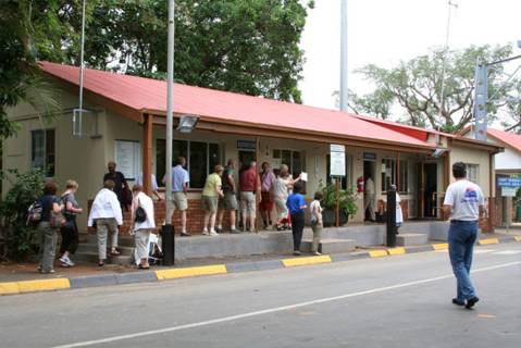 A line of people queuing outside a building